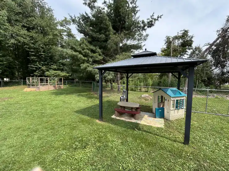 Outdoor gazebo and playhouse in the CBCA backyard