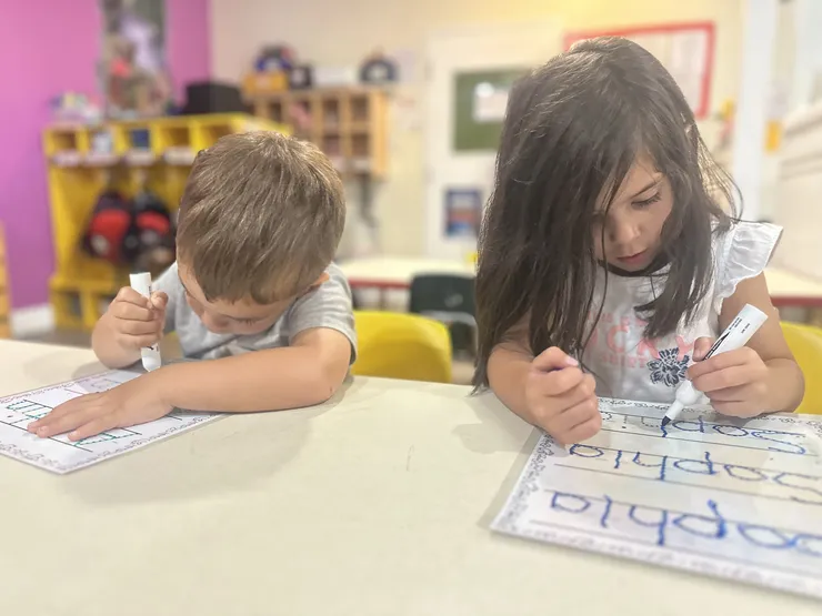 Preschoolers practicing writing at CB Children's Academy